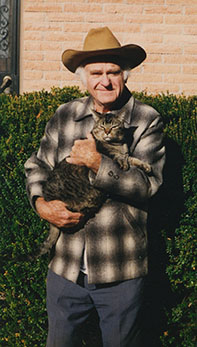 [Don Sayner in his cowboy hat his favorite cat: 156k]